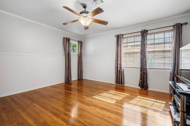 5519 Cheshire Ln, Houston, TX 77092 - spare room with wood finished floors, ceiling fan, wainscoting, ornamental molding, and baseboards