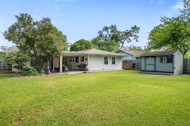 5519 Cheshire Ln, Houston, TX 77092 - back of property featuring a storage unit, a patio, and an outbuilding