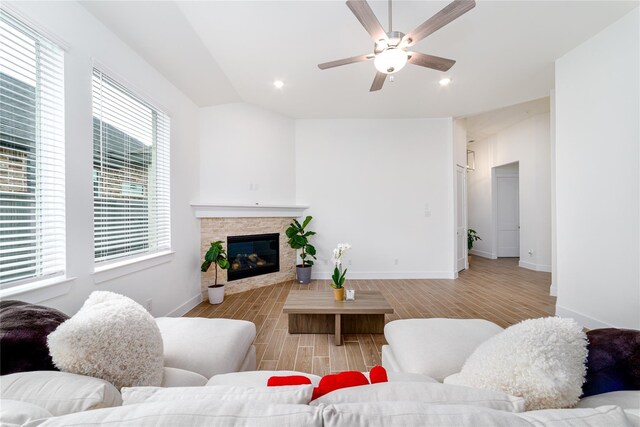 4603 Vaughan Way, Iowa Colony, TX 77583 - living room featuring light wood-style floors, a stone fireplace, a ceiling fan, baseboards, and recessed lighting