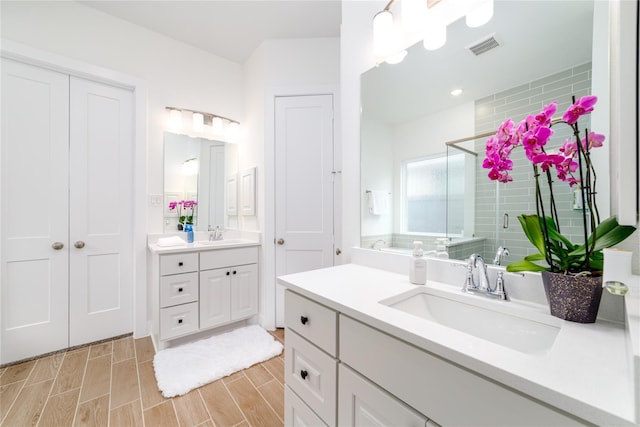 4603 Vaughan Way, Iowa Colony, TX 77583 - bathroom featuring a shower stall, two vanities, and wood finish floors