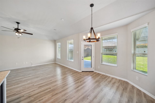20511 Kendall Cliff Ct, Katy, TX 77449 - unfurnished dining area featuring a chandelier, healthy amount of natural light, light wood-style floors, and baseboards