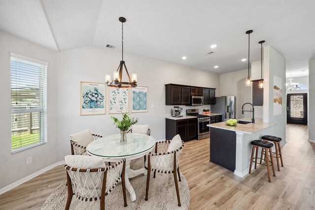 20511 Kendall Cliff Ct, Katy, TX 77449 - dining space featuring a chandelier, light wood finished floors, lofted ceiling, baseboards, and recessed lighting