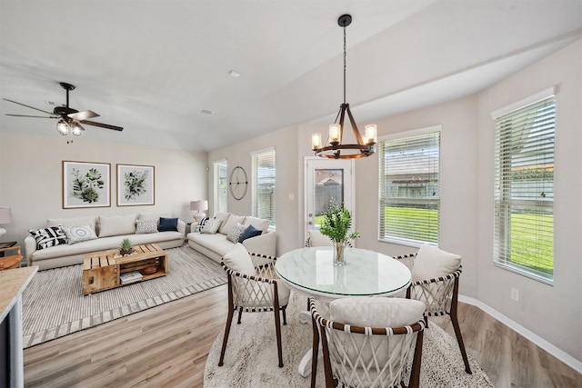 20511 Kendall Cliff Ct, Katy, TX 77449 - dining space with light wood-style floors, a chandelier, healthy amount of natural light, baseboards, and lofted ceiling