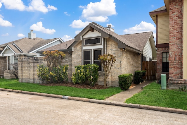 8621 Beechcrest St, Houston, TX 77083 - view of front facade with a chimney, brick siding, and a shingled roof
