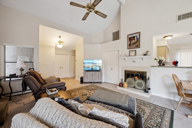 8621 Beechcrest St, Houston, TX 77083 - tiled living room with a ceiling fan, high vaulted ceiling, a glass covered fireplace, and a baseboard radiator