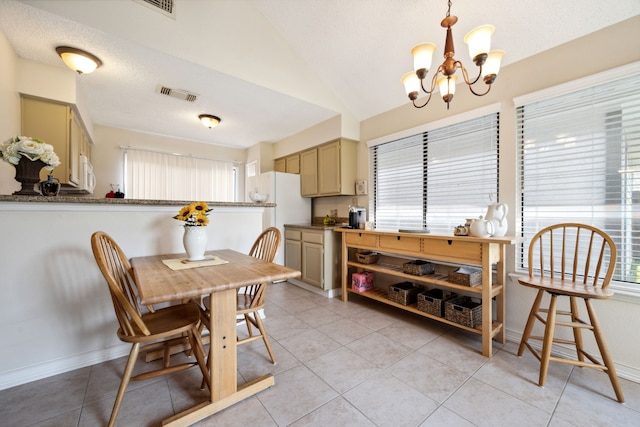 8621 Beechcrest St, Houston, TX 77083 - dining room with a chandelier, lofted ceiling, light tile patterned floors, and baseboards