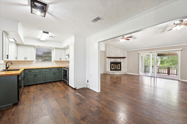 240 Berwick Dr, Bridge City, TX 77611 - kitchen with a ceiling fan, a sink, open floor plan, crown molding, and wooden counters