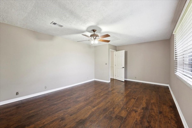 240 Berwick Dr, Bridge City, TX 77611 - empty room with a ceiling fan, dark wood finished floors, baseboards, and a textured ceiling