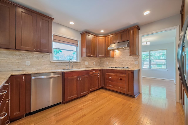 5243 Stillbrooke Dr, Houston, TX 77096 - kitchen with dishwasher, a sink, under cabinet range hood, light wood finished floors, and light stone counters