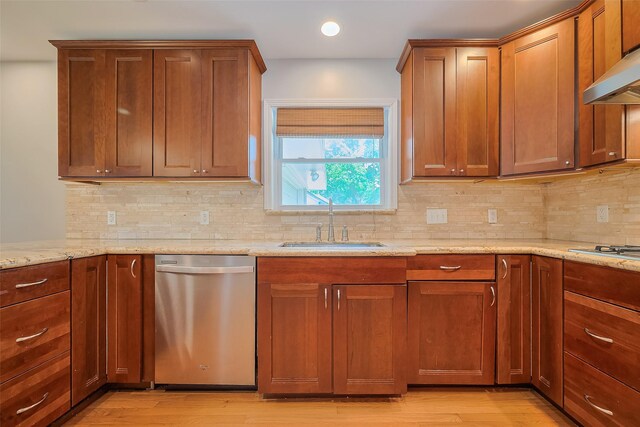 5243 Stillbrooke Dr, Houston, TX 77096 - kitchen with stainless steel appliances, a sink, under cabinet range hood, light stone counters, and light wood-style flooring