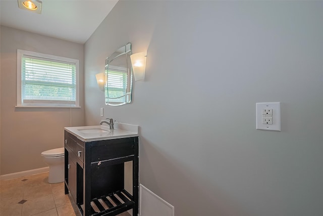 5243 Stillbrooke Dr, Houston, TX 77096 - bathroom with toilet, baseboards, vanity, and tile patterned floors