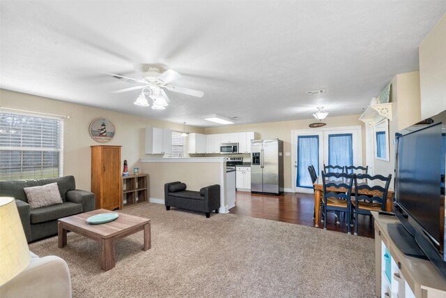 189 New Cove Dr, Livingston, TX 77351 - living area featuring dark colored carpet, ceiling fan, and baseboards