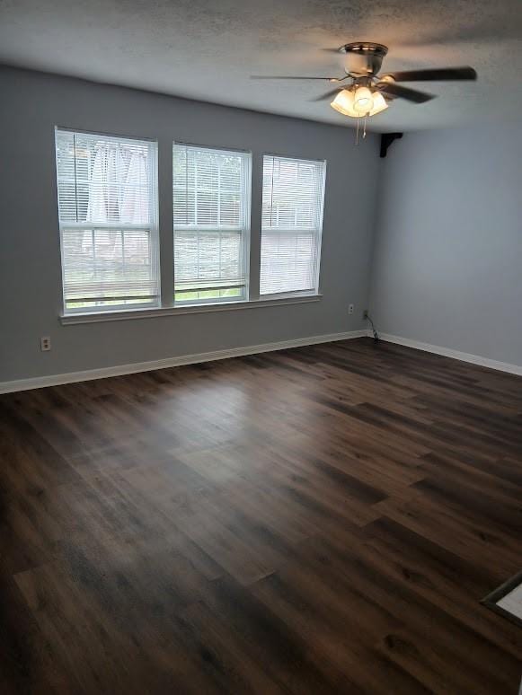 13523 La Concha Ln, Houston, TX 77083 - empty room featuring dark wood-type flooring, baseboards, and a ceiling fan