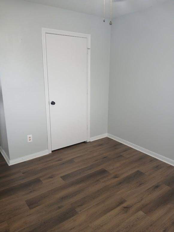13523 La Concha Ln, Houston, TX 77083 - unfurnished room with baseboards and dark wood-type flooring