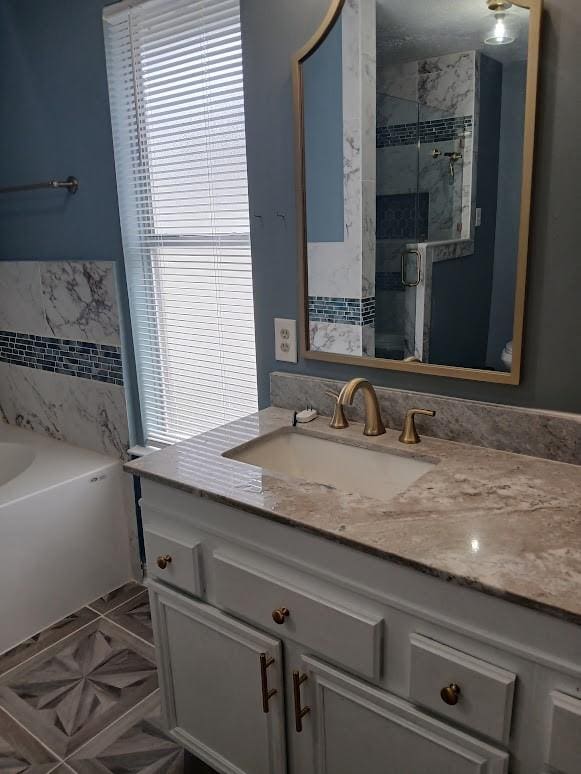 13523 La Concha Ln, Houston, TX 77083 - full bathroom featuring vanity, a garden tub, and a shower stall