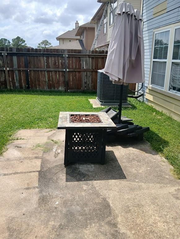 13523 La Concha Ln, Houston, TX 77083 - view of patio with an outdoor fire pit and central air condition unit