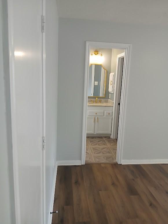 13523 La Concha Ln, Houston, TX 77083 - hall featuring baseboards and wood finished floors