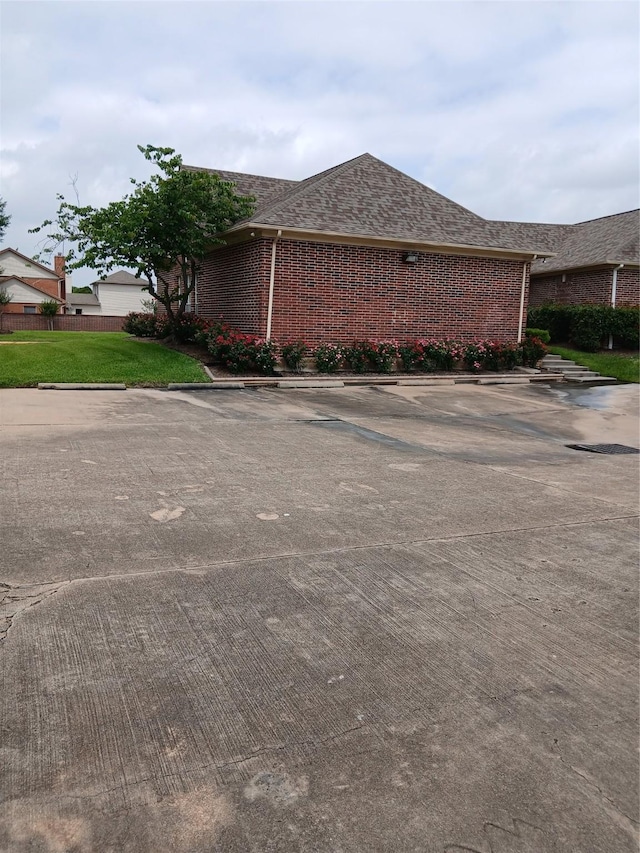 13523 La Concha Ln, Houston, TX 77083 - view of side of home with brick siding and roof with shingles