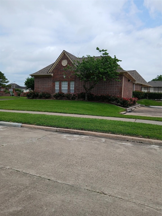 13523 La Concha Ln, Houston, TX 77083 - view of front of house featuring brick siding and a front yard