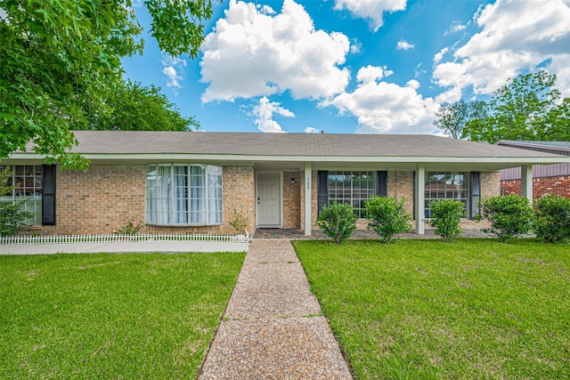 101 Wildrose St, Baytown, TX 77520 - ranch-style house featuring a front lawn and brick siding
