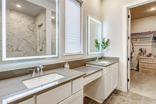 24910 Hibiscus Garden Way, Katy, TX 77493 - bathroom with a marble finish shower, vanity, a spacious closet, and recessed lighting