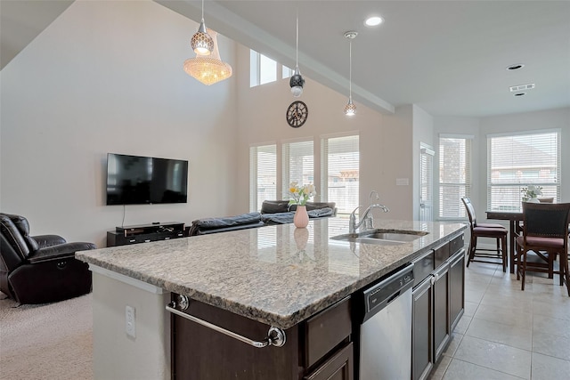 9823 Corben Creek Ln, Richmond, TX 77407 - kitchen featuring a sink, stainless steel dishwasher, dark brown cabinetry, decorative light fixtures, and vaulted ceiling