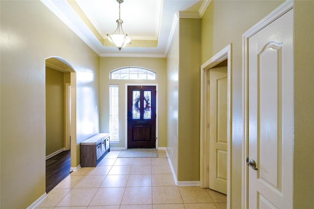5910 Hatfield Glen Dr, Katy, TX 77449 - entryway featuring a raised ceiling, crown molding, light tile patterned floors, and arched walkways