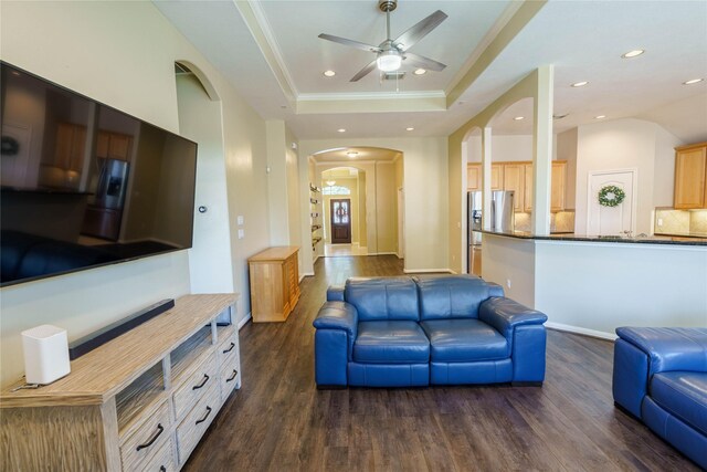 5910 Hatfield Glen Dr, Katy, TX 77449 - living area featuring arched walkways, dark wood-type flooring, a raised ceiling, recessed lighting, and ceiling fan