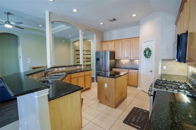 5910 Hatfield Glen Dr, Katy, TX 77449 - kitchen with a large island, black microwave, stainless steel fridge, arched walkways, and a ceiling fan