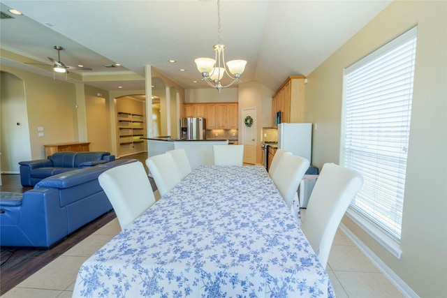 5910 Hatfield Glen Dr, Katy, TX 77449 - dining area with arched walkways, light tile patterned floors, a chandelier, ceiling fan, and recessed lighting