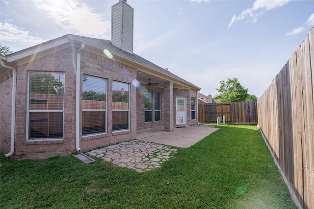 5910 Hatfield Glen Dr, Katy, TX 77449 - rear view of house with a ceiling fan, a fenced backyard, a chimney, brick siding, and a patio area