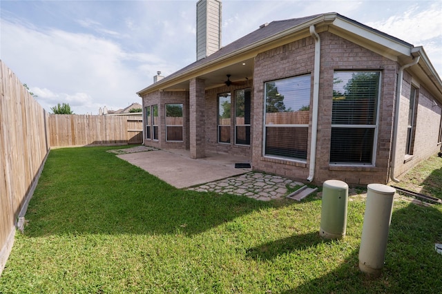 5910 Hatfield Glen Dr, Katy, TX 77449 - rear view of house featuring a chimney, a ceiling fan, brick siding, a fenced backyard, and a patio area