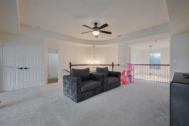 8113 Tranquil Lake Way, Conroe, TX 77385 - carpeted living area featuring a tray ceiling and a ceiling fan