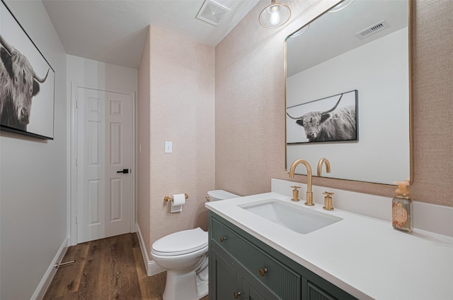 8113 Tranquil Lake Way, Conroe, TX 77385 - half bath with wood finished floors, toilet, vanity, and baseboards