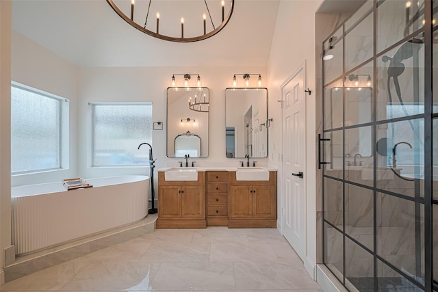 8113 Tranquil Lake Way, Conroe, TX 77385 - full bathroom with a chandelier, double vanity, a freestanding tub, and a shower stall