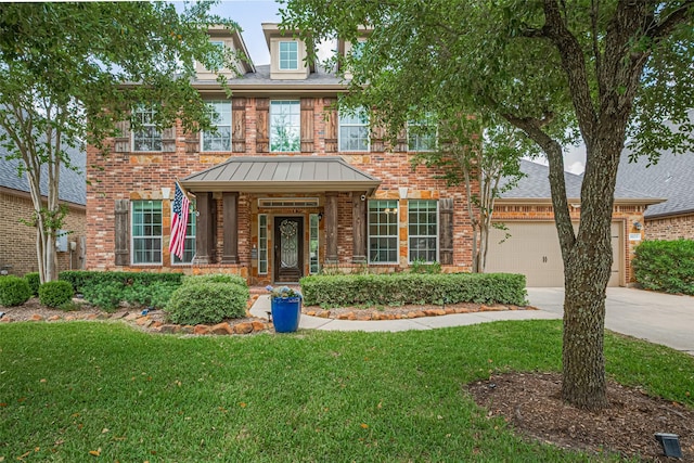8113 Tranquil Lake Way, Conroe, TX 77385 - view of front of house featuring brick siding, driveway, a front lawn, and a standing seam roof