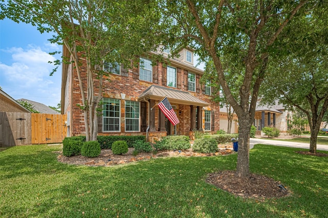 8113 Tranquil Lake Way, Conroe, TX 77385 - view of front of property featuring a gate, a standing seam roof, brick siding, and metal roof