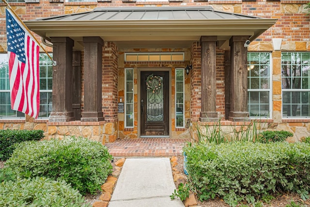 8113 Tranquil Lake Way, Conroe, TX 77385 - doorway to property featuring a standing seam roof and brick siding