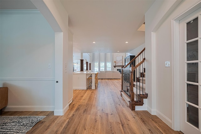 8113 Tranquil Lake Way, Conroe, TX 77385 - corridor featuring light wood-type flooring, stairs, baseboards, and recessed lighting