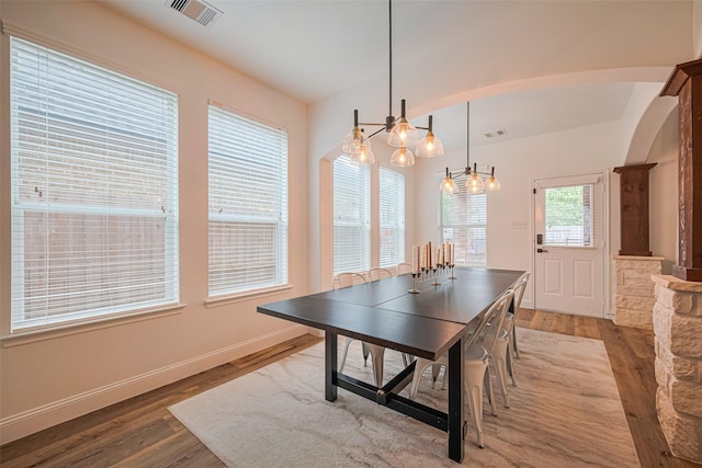 8113 Tranquil Lake Way, Conroe, TX 77385 - dining room with wood finished floors, baseboards, and arched walkways