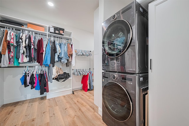 8113 Tranquil Lake Way, Conroe, TX 77385 - washroom featuring stacked washer / drying machine, wood finished floors, and baseboards