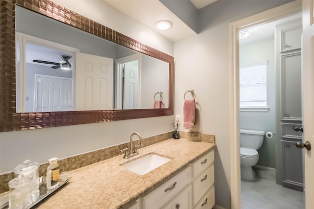 20727 Sea Pine Dr, Katy, TX 77450 - bathroom with toilet, vanity, ceiling fan, wood finished floors, and baseboards