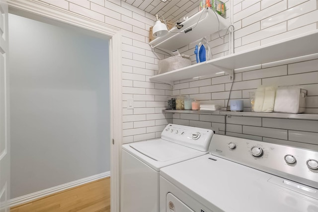 20727 Sea Pine Dr, Katy, TX 77450 - washroom with washer and clothes dryer, baseboards, and light wood finished floors