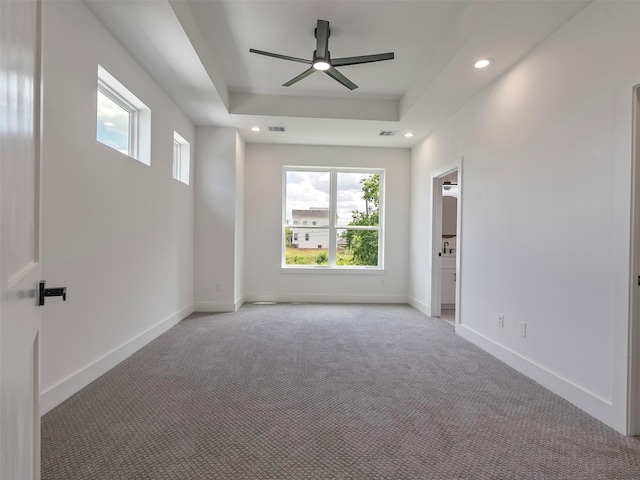 2207 Dan St, Houston, TX 77020 - spare room featuring light carpet, a tray ceiling, ceiling fan, and recessed lighting