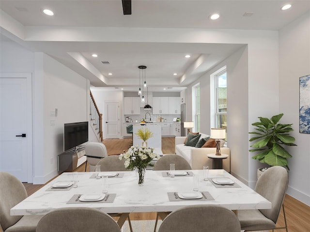 2207 Dan St, Houston, TX 77020 - dining room with a raised ceiling, light wood-style floors, stairs, and recessed lighting
