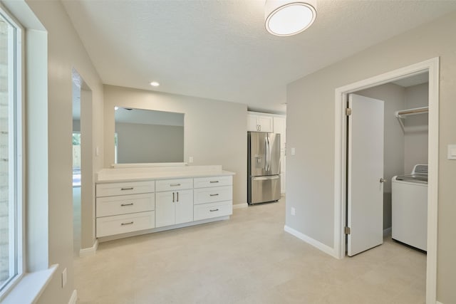 60 Hickory Oak Dr, The Woodlands, TX 77381 - unfurnished bedroom featuring stainless steel fridge, washer / dryer, baseboards, a textured ceiling, and recessed lighting