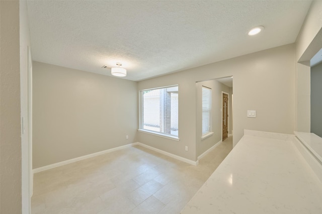60 Hickory Oak Dr, The Woodlands, TX 77381 - empty room with a textured ceiling and baseboards