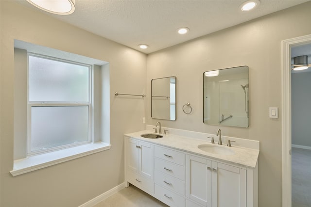 60 Hickory Oak Dr, The Woodlands, TX 77381 - bathroom with baseboards, double vanity, and recessed lighting
