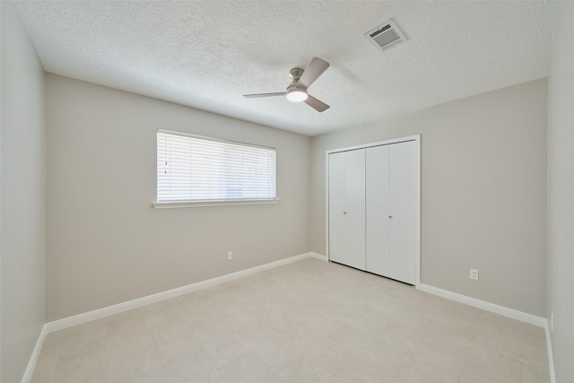 60 Hickory Oak Dr, The Woodlands, TX 77381 - unfurnished bedroom featuring a textured ceiling, a closet, baseboards, and ceiling fan