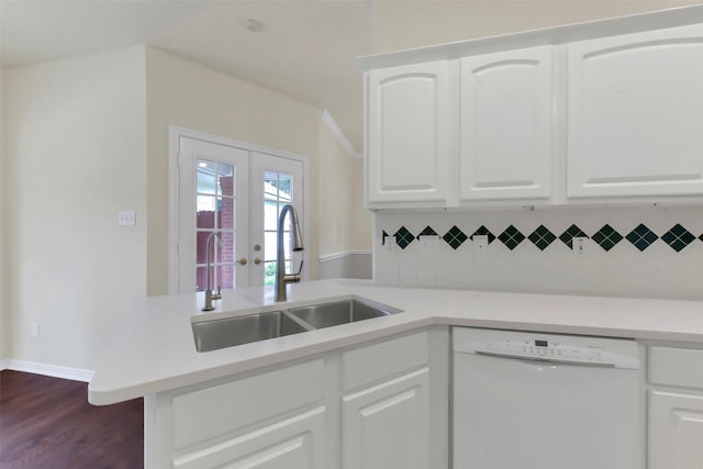 kitchen with dishwasher, a sink, decorative backsplash, and light countertops